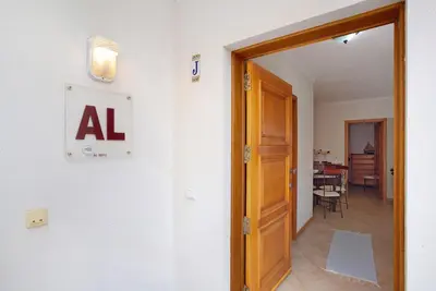 a hallway with an open door and a dining room at Apartamento A Quinta Porto Santo in Campo de Baixo