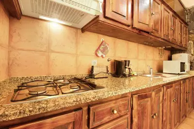 a kitchen with a stove and a counter top at Casa Cristina in Santo da Serra