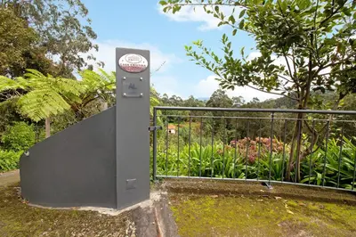 a gate with a sign on it next to a fence at Casa Cristina in Santo da Serra