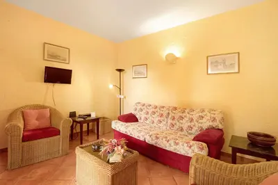a living room with a couch and two chairs at Casa Cristina in Santo da Serra