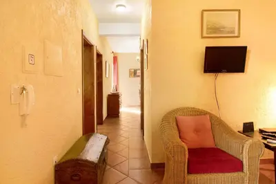a hallway with a chair and a phone in a room at Casa Cristina in Santo da Serra