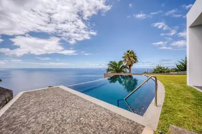 a swimming pool with a view of the ocean at Vila Aguarelas with pool by Stay Madeira Island in Arco da Calheta