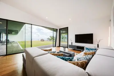 a living room with a white couch and a tv at Vila Aguarelas with pool by Stay Madeira Island in Arco da Calheta