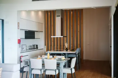 a kitchen and dining room with a table and chairs at Vila Aguarelas with pool by Stay Madeira Island in Arco da Calheta