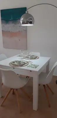 a white table with wine glasses on top of it at Appartement Willy St. James Luz in Luz