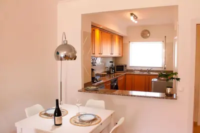 a kitchen with a table with a wine bottle on it at Appartement Willy St. James Luz in Luz