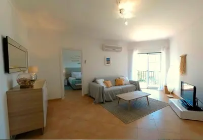 a living room with a couch and a tv at Appartement Willy St. James Luz in Luz