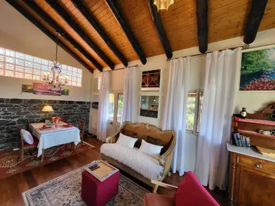 a living room with a table and a couch at Boutique Chalet in Calheta in Arco da Calheta