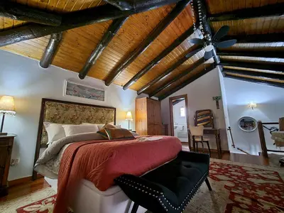 a bedroom with a bed and a wooden ceiling at Boutique Chalet in Calheta in Arco da Calheta