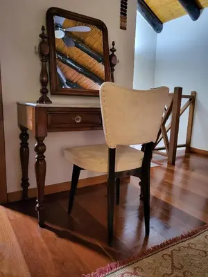 a chair sitting in front of a desk with a mirror at Boutique Chalet in Calheta in Arco da Calheta