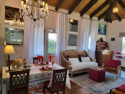a living room with a table and a couch at Boutique Chalet in Calheta in Arco da Calheta