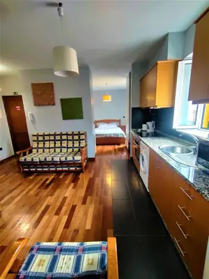 a kitchen with a couch and a bed in a room at Funchal Old Town Studios - Historic Atlantic View in Funchal
