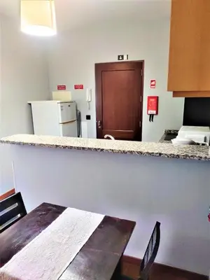 a kitchen with a counter top and a table at Funchal Old Town Studios - Historic Atlantic View in Funchal