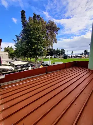 a wooden deck on a roof with a tree at Funchal Old Town Studios - Historic Atlantic View in Funchal