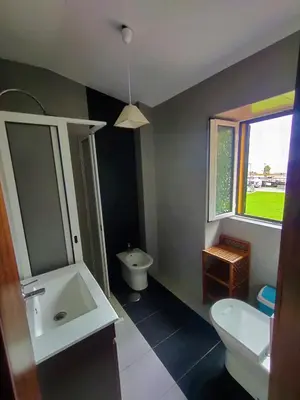 a bathroom with a sink and a toilet and a window at Funchal Old Town Studios - Historic Atlantic View in Funchal