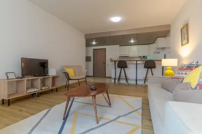 a living room with a white couch and a table at avenida arriaga 405 in Funchal