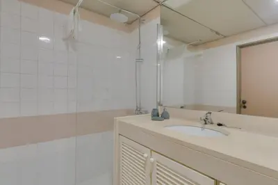 a bathroom with a sink and a shower and a mirror at avenida arriaga 405 in Funchal