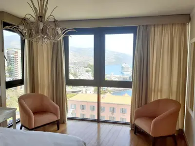 a bedroom with two chairs and a large window at Modern apartment in Funchal 60 m² with shared pool in Funchal