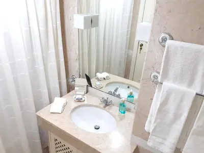 a bathroom with a sink and a mirror at Modern apartment in Funchal 60 m² with shared pool in Funchal
