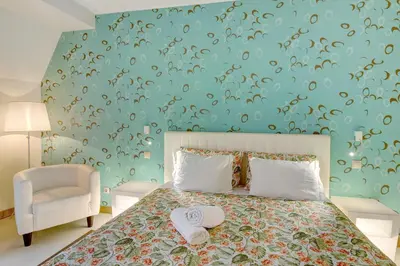 a bedroom with a bed and a blue wall at Dfm Happy Days F - Funchal in Funchal