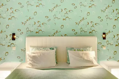 a bedroom with a bed and a wall with brown butterflies at Dfm Happy Days C - Funchal in Funchal