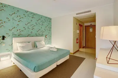 a bedroom with a bed with a blue wall at Dfm Happy Days C - Funchal in Funchal