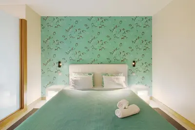 a bedroom with a bed with two towels on it at Dfm Happy Days C - Funchal in Funchal