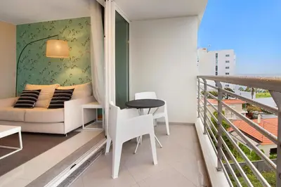 a living room with a couch and a table on a balcony at Dfm Happy Days B - Funchal in Funchal