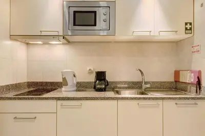 a kitchen with a sink and a microwave at Dfm Happy Days B - Funchal in Funchal