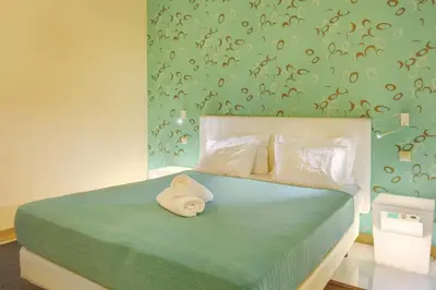 a bedroom with a bed with two towels on it at Dfm Happy Days B - Funchal in Funchal