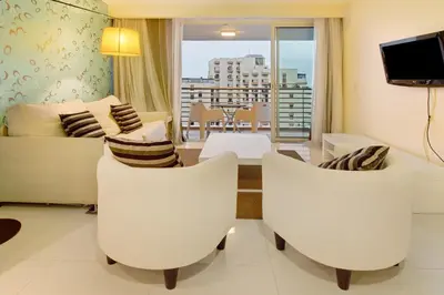 a living room with white furniture and a balcony at Dfm Happy Days B - Funchal in Funchal