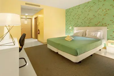 a bedroom with a bed with a teddy bear on it at Dfm Happy Days B - Funchal in Funchal