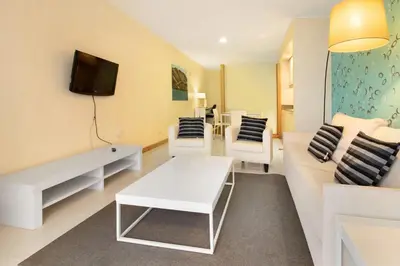 a living room with a couch and a tv at Dfm Happy Days B - Funchal in Funchal