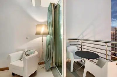 a living room with a chair and a table and a window at Dfm Happy Days D - Funchal in Funchal