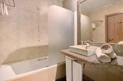 a bathroom with a sink and a bath tub at Dfm Happy Days D - Funchal in Funchal