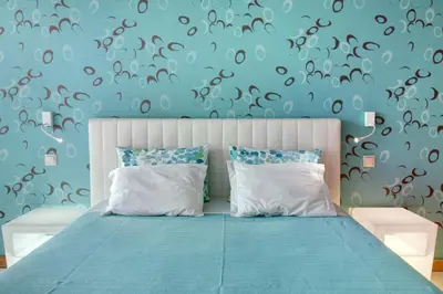 a bedroom with a bed and a blue wall at Dfm Happy Days D - Funchal in Funchal