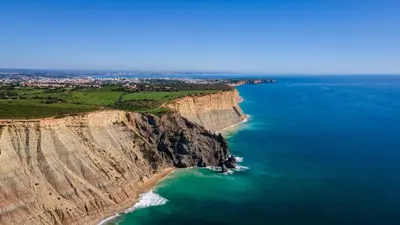 an aerial view of the ocean and cliffs at CoolHouses Algarve Luz, 3 Bed Townhouse, central & superb view, Casa Salute (100066/AL) in Luz