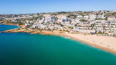 an aerial view of a beach and buildings at CoolHouses Algarve Luz, 3 Bed Townhouse, central & superb view, Casa Salute (100066/AL) in Luz