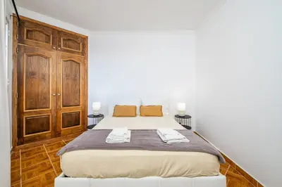 a bedroom with a bed with two towels on it at Sunset House in Ribeira Brava