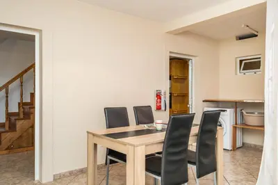 a dining room with a table and chairs at Sunset House in Ribeira Brava