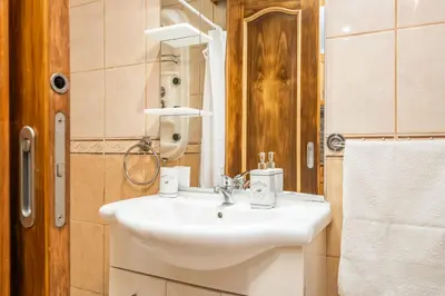 a bathroom with a white sink and a mirror at Sunset House in Ribeira Brava
