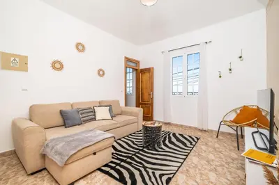 a living room with a couch and a rug at Sunset House in Ribeira Brava