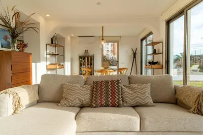 a couch with pillows on it in a living room at Casa Paul do Mar in Paul do Mar