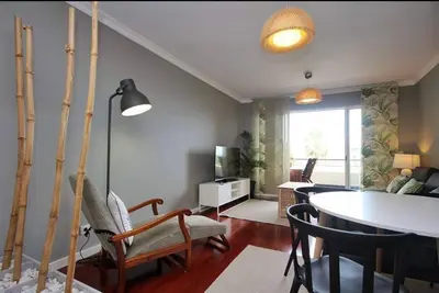 a living room with a table and chairs and a dining room at Seashell II in Funchal