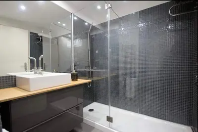 a bathroom with a shower and a sink and a tub at Seashell II in Funchal