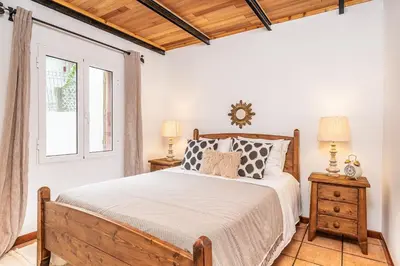 a bedroom with a bed and a window at Ivy Cottage by Homie in São Roque do Faial