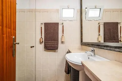 a bathroom with a sink and a mirror at Ivy Cottage by Homie in São Roque do Faial