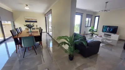 a living room with a table and a dining room at Villa Strelitzia in Funchal