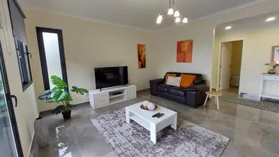 a living room with a couch and a tv at Villa Strelitzia in Funchal