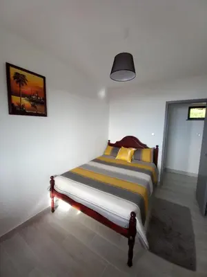 a bedroom with a bed in a white wall at Casa dos Avós Domingos & Matilde in Estreito da Calheta